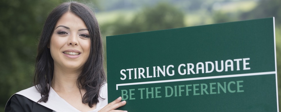 Stirling graduate Monika Gopal holding sign saying 'be the difference'