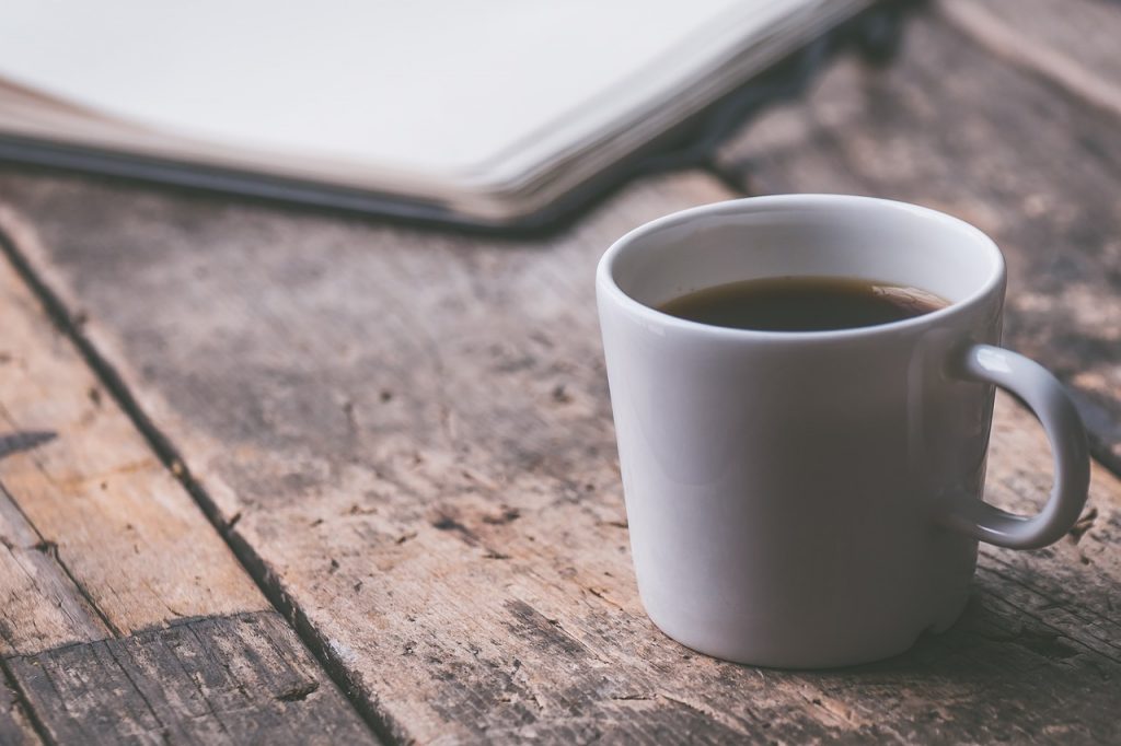 Coffee and a notepad on a desk – all part of a balanced routine – ideal if you're planning a return to study.
