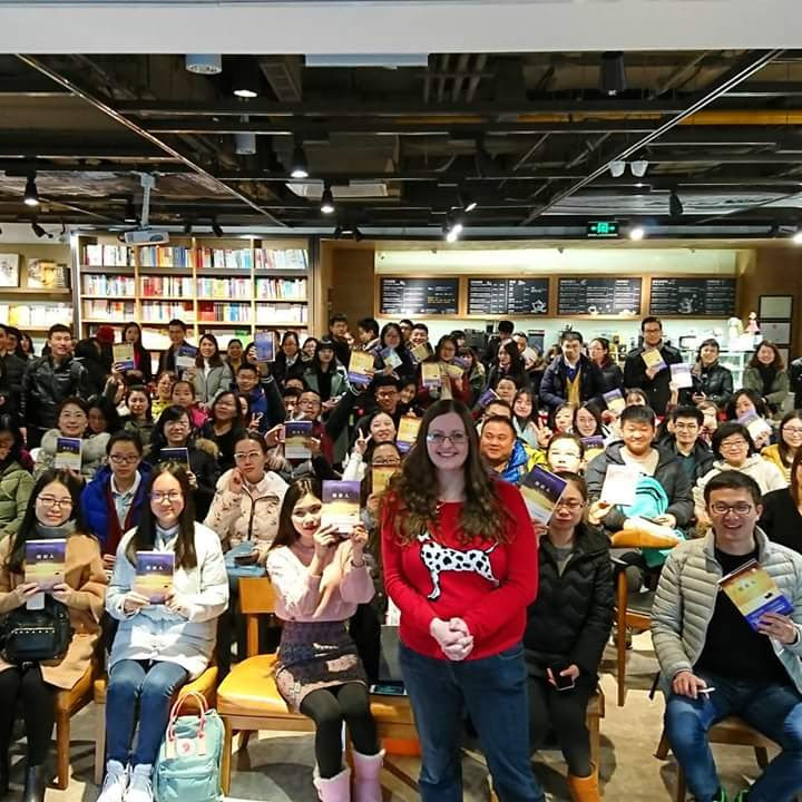 Author standing up with audience behind her at a book event in China.