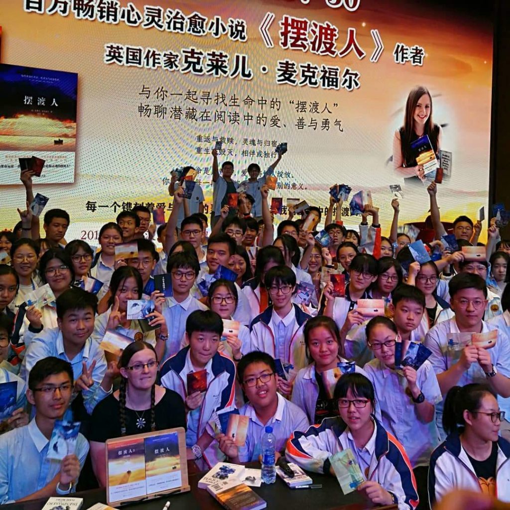 Author smiling at a book event in China. 