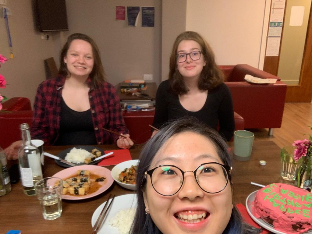 Three students having dinner together in their student accommodation